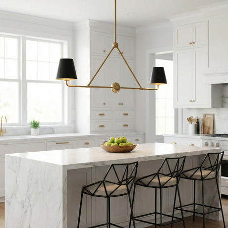 A white transitional kitchen features a Banks 2 Shade Linear Pendant 42 inch, Matte Black and Brass hanging over a marble waterfall island with black geometric stools.