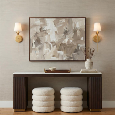 A transitional foyer with the Alice Single Wall Sconce 21", Antique Gold with linen shades flanking a large abstract painting above a marble console table.