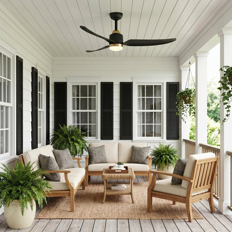 A farmhouse porch featuring the Kent LED Outdoor Ceiling Fan with Light 52", Brushed Brass and Matte Black on a white ceiling with siding, shutters and potted ferns.