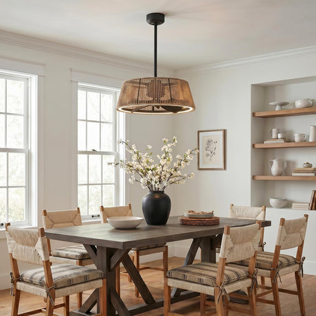 A modern farmhouse dining room with the Elwood LED Ceiling Fan 24", Matte Black with Braided Rope positioned over a dark wood table with woven chairs.