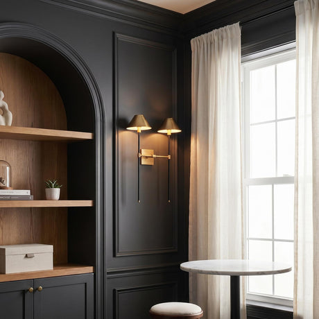 A transitional office featuring the Sylas Double Wall Sconce 26", Antique Brass and Black mounted on charcoal walls beside an arched oak bookshelf and marble bistro table.