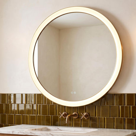 A contemporary bathroom featuring the Hedley Round LED Mirror 36" x 36", Modern Brass mounted over a white marble vanity and olive green vertical fluted tiles.