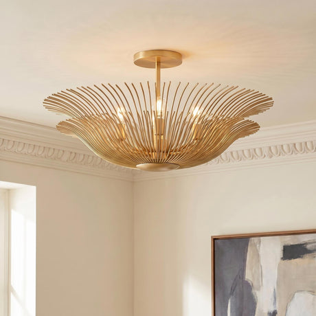 A transitional living room featuring a gilded brass semi-flush mount fixture installed on the ceiling center near ornate crown molding and framed abstract wall art.