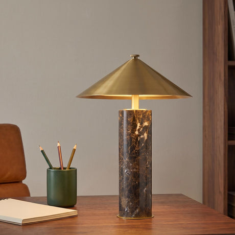 A mid-century office with the Gentry Rechargeable Table Lamp 15", Marble and Aged Brass featuring a cone shade on a walnut desk beside a leather chair.