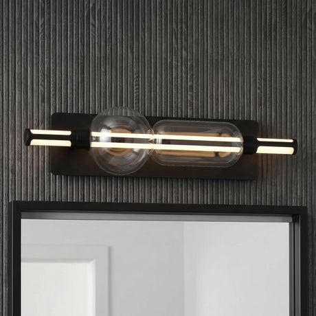 A modern bathroom featuring a Latimer LED Vanity Light 26" in matte black and clear glass mounted above a mirror on a dark grey slat wall.