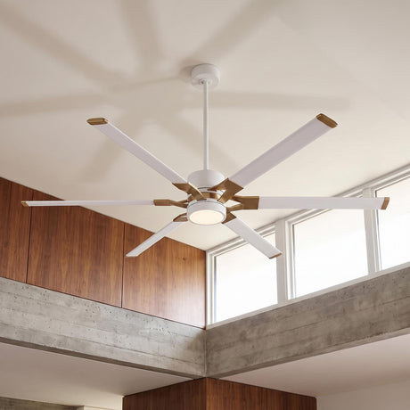 A modern living room features the Loon LED Ceiling Fan 72" Matte White with Modern Brass mounted beside concrete ledges and warm wood paneling.
