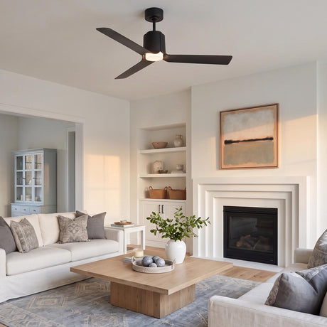 A contemporary living room with the matte black Condor LED Ceiling Fan 52" mounted along the ceiling center above a white fireplace and wood block coffee table.