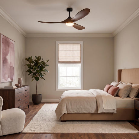 A transitional bedroom with an Egret LED Ceiling Fan featuring walnut wood blades and a matte black finish centered on a ceiling above a tan upholstered bed.