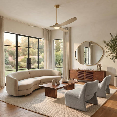 A contemporary living room with the Egret LED Ceiling Fan 70", Whitewash Oak and Modern Brass centered above a curved beige sofa and a walnut coffee table.