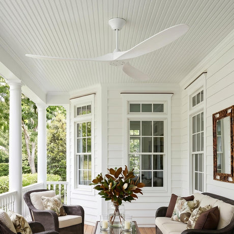 A modern farmhouse porch with the Egret Ceiling Fan 70" Matte White Oak in a matte white oak finish on a beadboard ceiling above dark wicker furniture.
