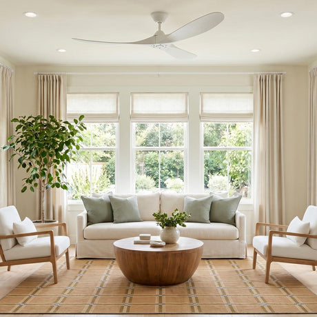 A transitional porch with an Egret Outdoor Ceiling Fan 60", Matte White on the white ceiling above large windows, featuring a tan plaid rug and potted tree.