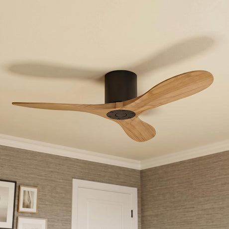A mid-century bedroom featuring an Eider Ceiling Fan with natural oak blades and matte black motor housing mounted in the ceiling center above textured gray grasscloth wallpaper.