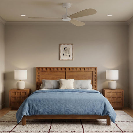 A transitional bedroom featuring the Willet Smart Ceiling Fan 60 in matte white and bleached oak above a wood bed with blue bedding and ceramic lamps.