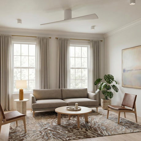 A contemporary living room featuring a Finch Smart Ceiling Fan 52", Matte White Oak with matte white blades mounted to the ceiling center over a beige sofa.