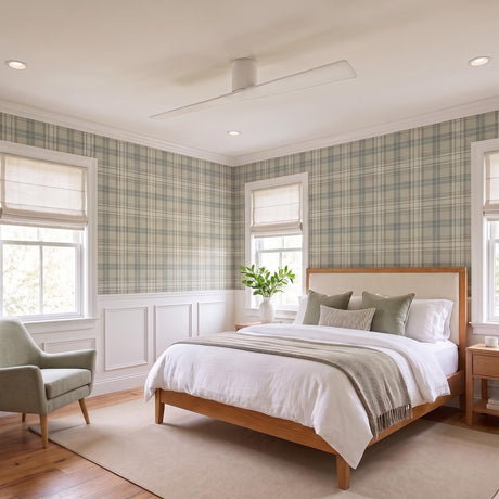 A transitional bedroom featuring the Finch Smart Ceiling Fan 60 in matte white oak centered on the ceiling above a wooden bed frame and plaid wallpaper.