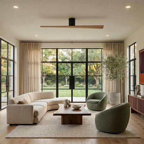 A modern living room with the Finch Smart Ceiling Fan 60 inch in natural oak and matte black over a curved cream sofa and large windows.