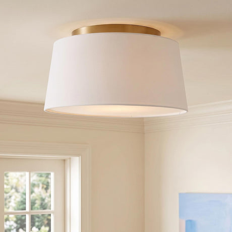 A transitional foyer with the Barton Medium Flush Mount 18" in aged brass and white linen along the ceiling with crown molding and a paneled door.
