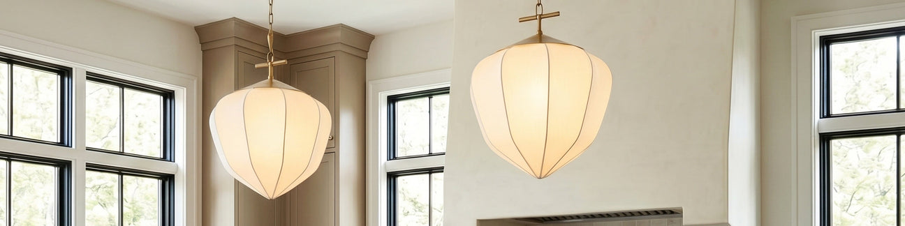 Two Chiya Large Fabric Pendants with patin brass hardware, Japandi style, are hung in a large kitchen.